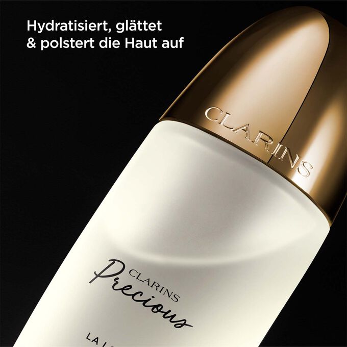 Clarins Precious La Lotion mit einem Text, der die Feuchtigkeit spendende, glättende und aufpolsternde Wirkung hervorhebt.