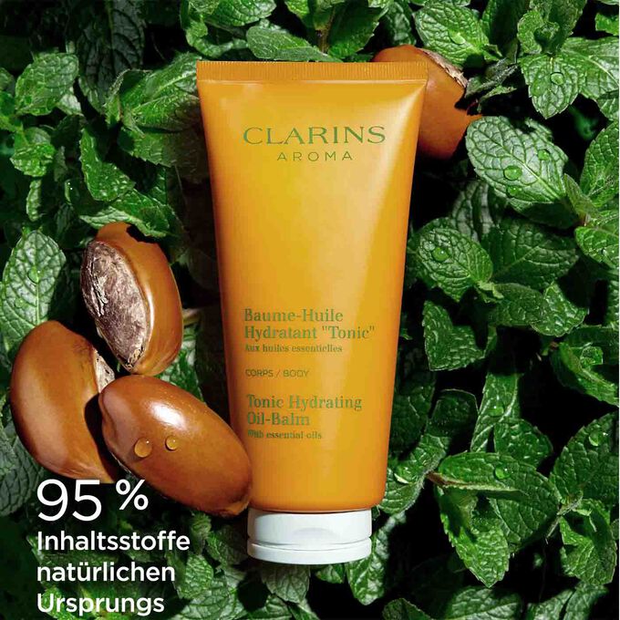 Tube Clarins Baume-Huile Tonic auf Ackerminze und Sheanüssen mit Textinfo, dass 95% Inhaltsstoffe natürlichen  Ursprungs sind