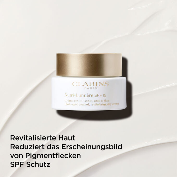 Tagescreme gegen dunkle Flecken mit SPF 15 auf Creme-Hintergrund mit Textinfo zur hautrevitalisierenden Wirkung