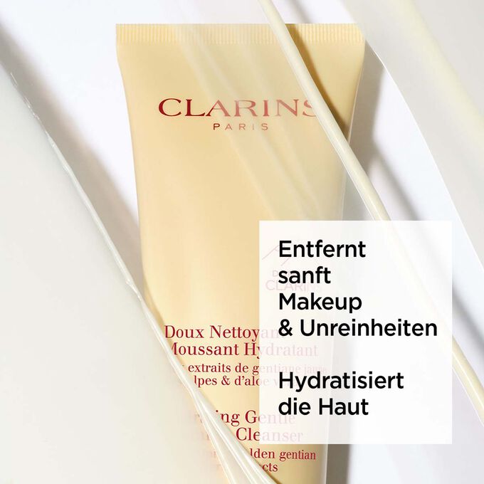 Gelbe Tube von Clarins Doux Nettoyant Moussant Hydratant unter Schaum mit Text über seine beruhigende Wirkung