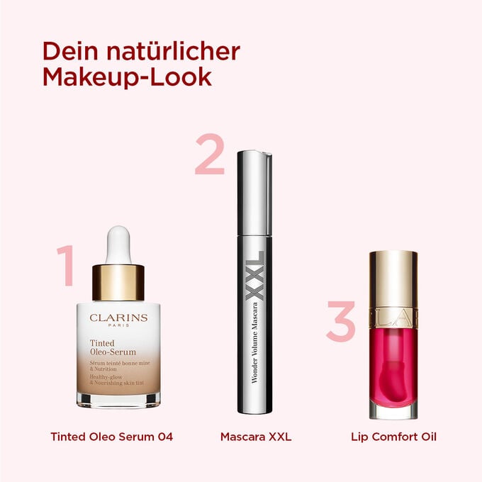 Clarins Makeup-Auswahl für einen natürlichen Look mit getöntem Serum, volumengebender Mascara und rotem Lippenöl.