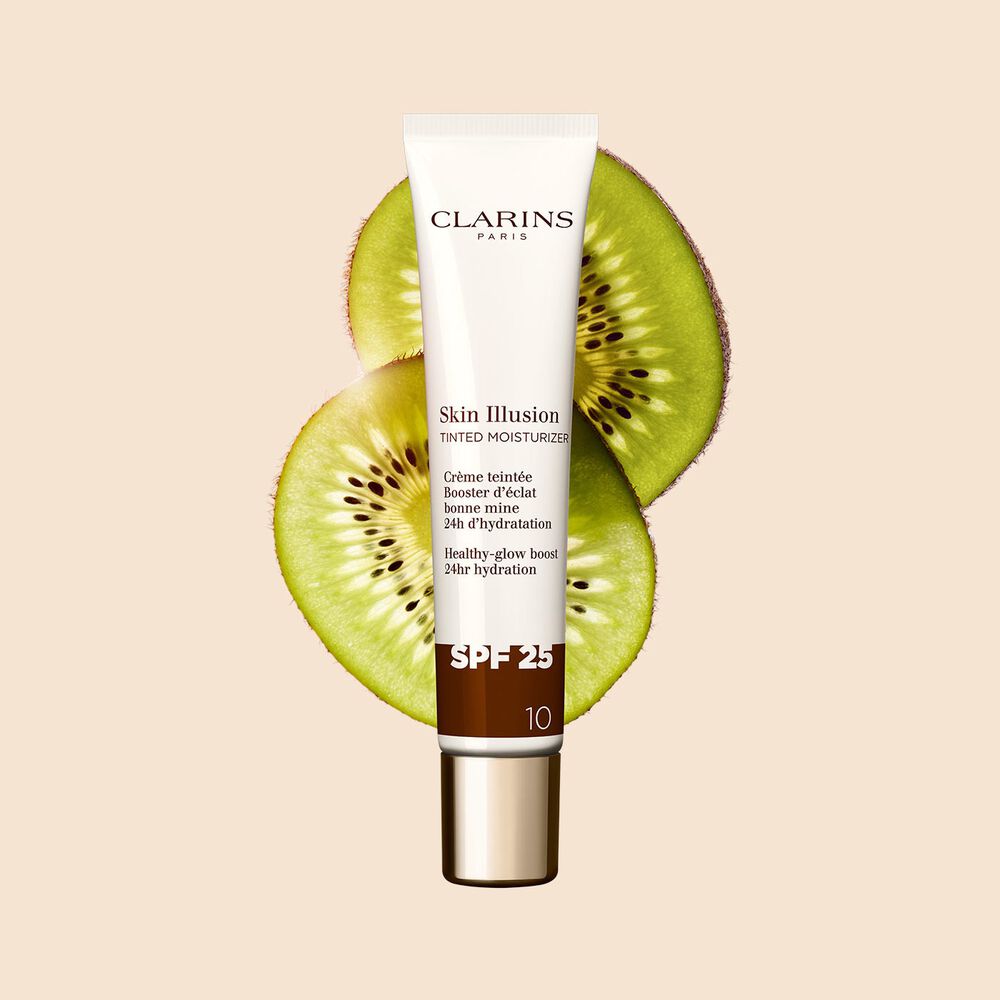 Tube Skin Illusion Tinted Moisturizer 40 ml, Farbton 10 zwischen Kiwischeiben auf beigem Hintergrund