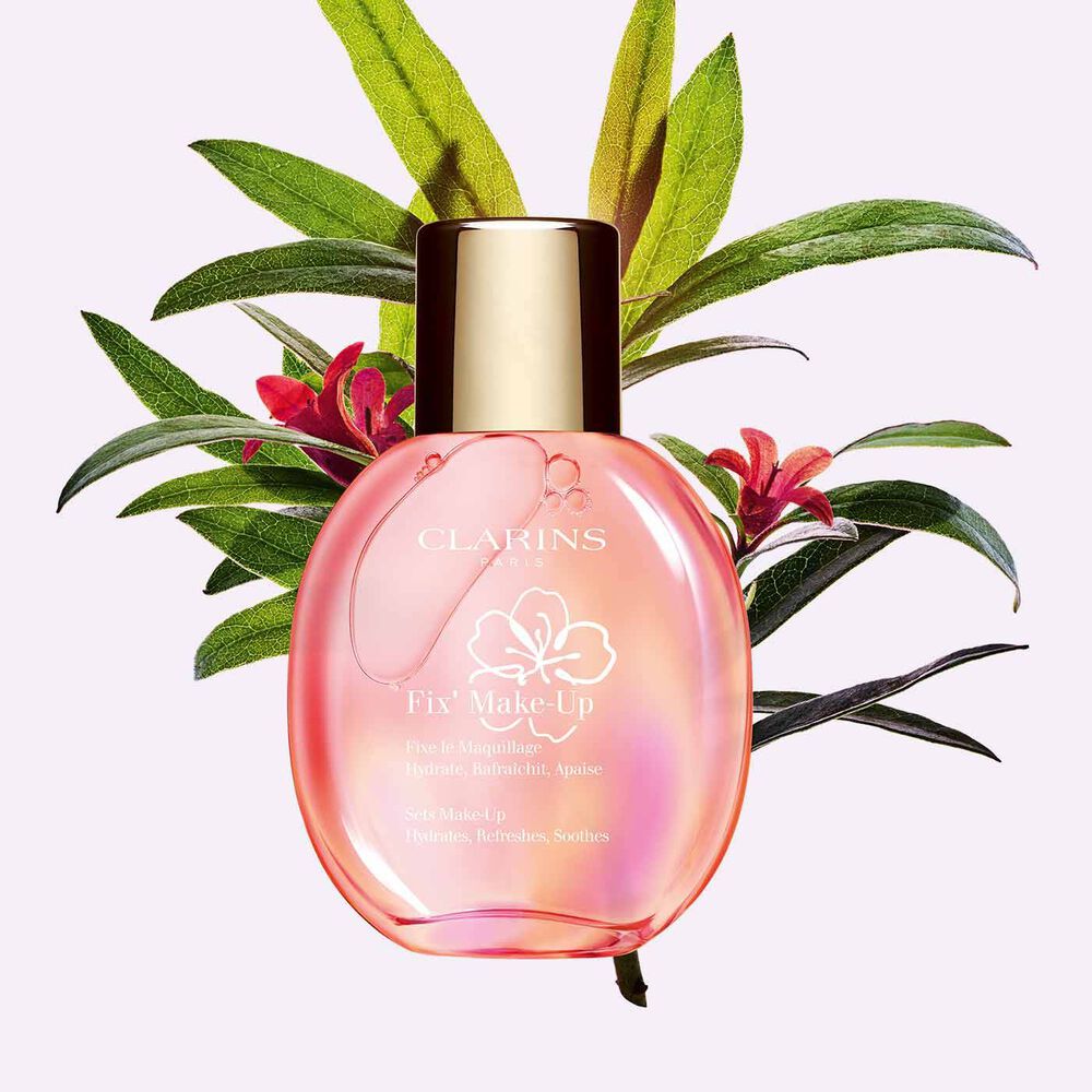 Packshot of a bottle of Clarins Fix' make up spray next to a bouquet of Alpenrose flower to emphasise its key ingredient.