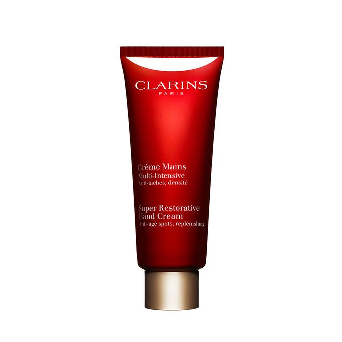 Tube Clarins Multi-Intensive Handcreme mit Haronga-Bl&auml;ttern auf rosa Hintergrund.