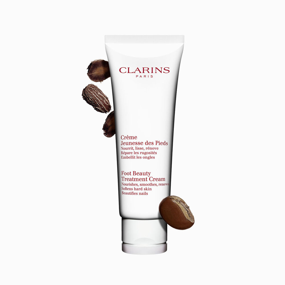 Tube Clarins Jeunesse des Pieds mit Sheanüssen auf weißem Hintergrund.
