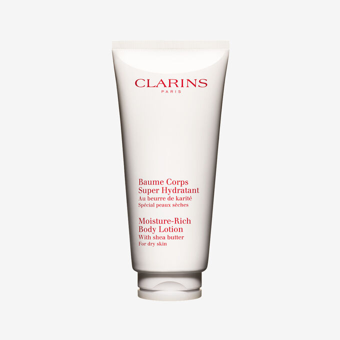 Flakon Clarins Body Lotion Baume Coprs Super Hydratant mit zwei Shean&uuml;ssen auf wei&szlig;en Hintergrund